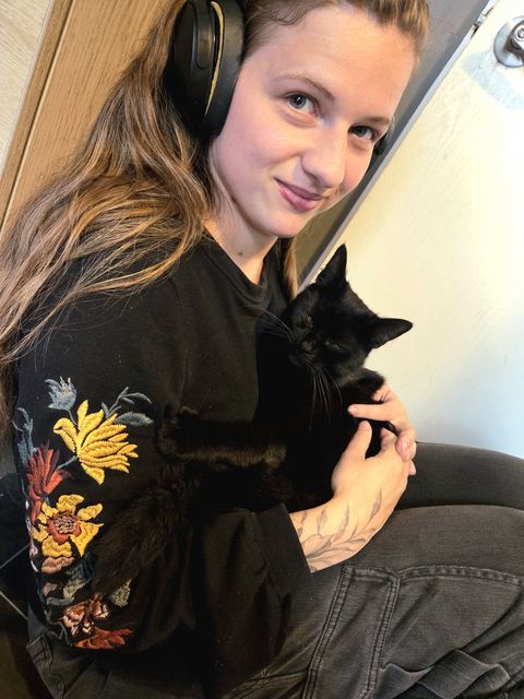 Becca at home with her black cat